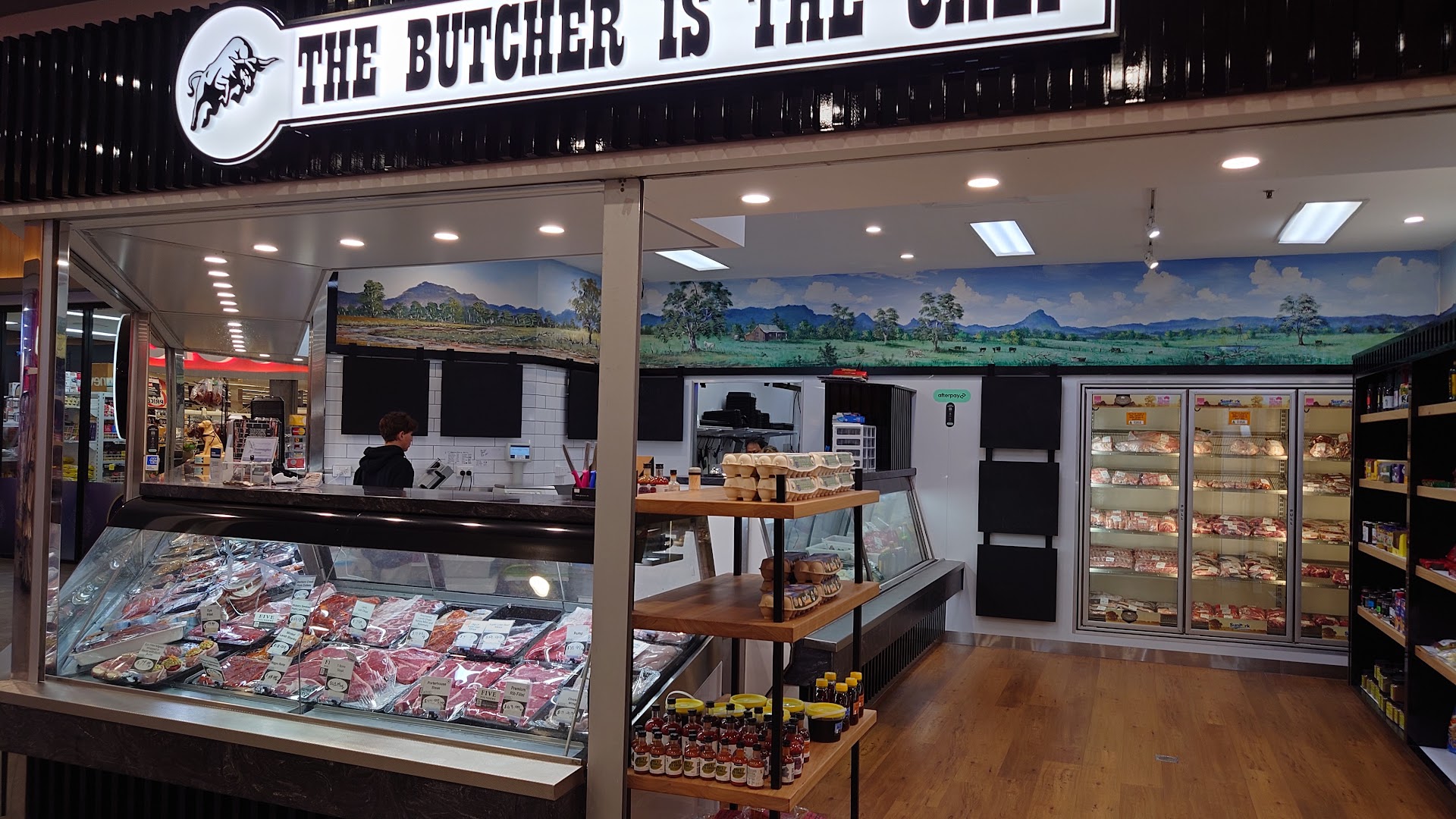 Inside the shop: the full meat cabinet, country mural, egg stand and stocked display freezers